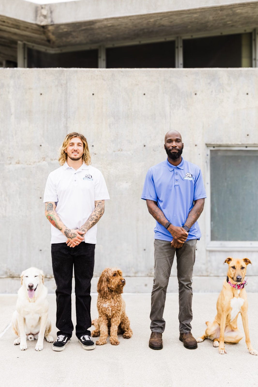 Wesley Dawe and Anthony Mason standing outdoors with three dogs Wesley Dawe and Anthony Mason standing outdoors with three dogs