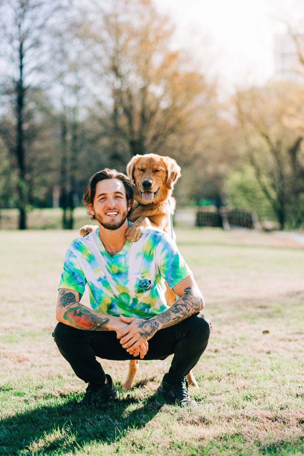 Wesley Dawe outdoors with a golden retriever resting its paws on his shoulders Wesley Dawe outdoors with a golden retriever resting its paws on his shoulders